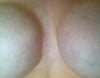 Muscles flexed demonstrating a straight edge on the inner cleavage of my right breast