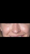 Smiling.