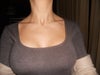 in a top wearing a bra with no cup support.