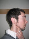 My best guess on the chin is that it's at least 1 cm behind the "frankfort plane" drawn down from my brow. Using my finger to highlight the jawline.