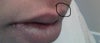 It does not look as visible in the pictures, but is clearly visible in person because of the difference in color from my skin.