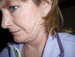 Later sweep on left side of face with head slightly tipped forward.