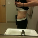 7 weeks po at the gym, side, flexing.
