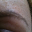 Pre-shot. Grey tattoo with some out-of-line stripes. Way too thick on this side, and not to brief (I wanted them thickest near my nose then to taper out over the arch).