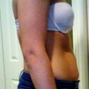 Skinny jeans and bra on to side