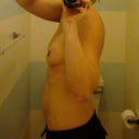 Flat little boobs and a round belly.