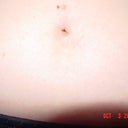 bellybutton, flat with just a tiny hole, very unnatural looking