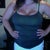 Tank top pic w that same little spots bra- 7 months after surge-- 640cc & 660 cc High profile implants Sub glandular (about muscle) Scar is under my breast.