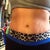 7 months PO. Front view wearing yoga pants. Flat and fit. Remaining stretch marks that could not be removed.